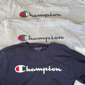 3 Champion shirts size adult small. 2 gray short sleeve, 1 navy long sleeve